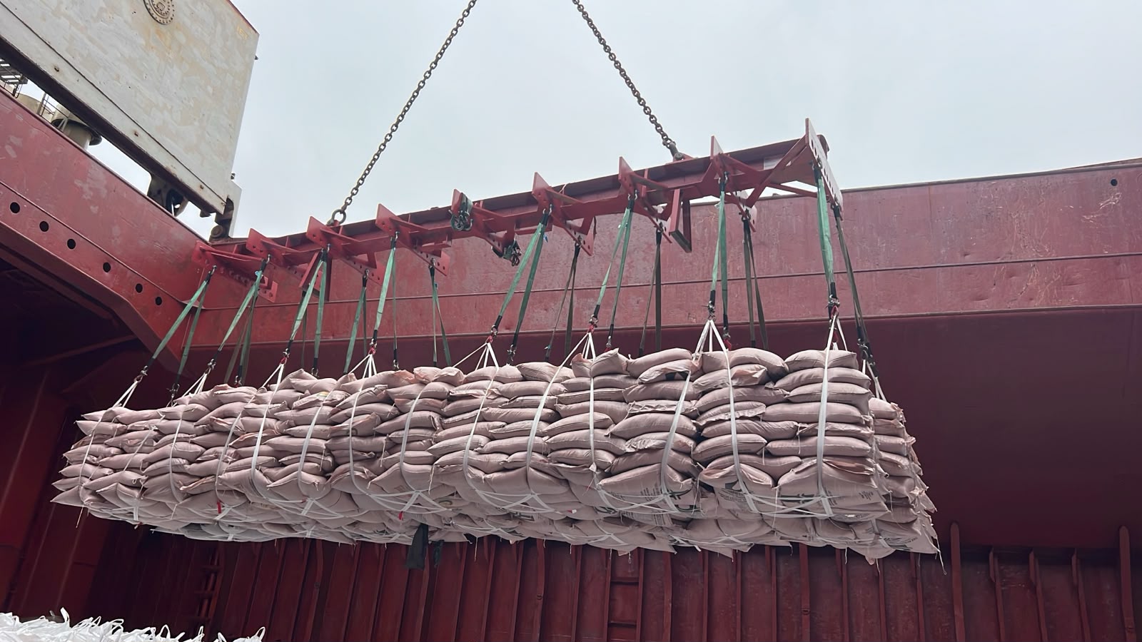 Sugar sacks hoisted while a vessel is loaded